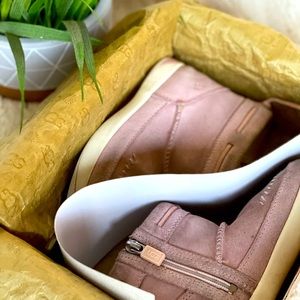 Little girl, pink UGG boots. Moccasin style.